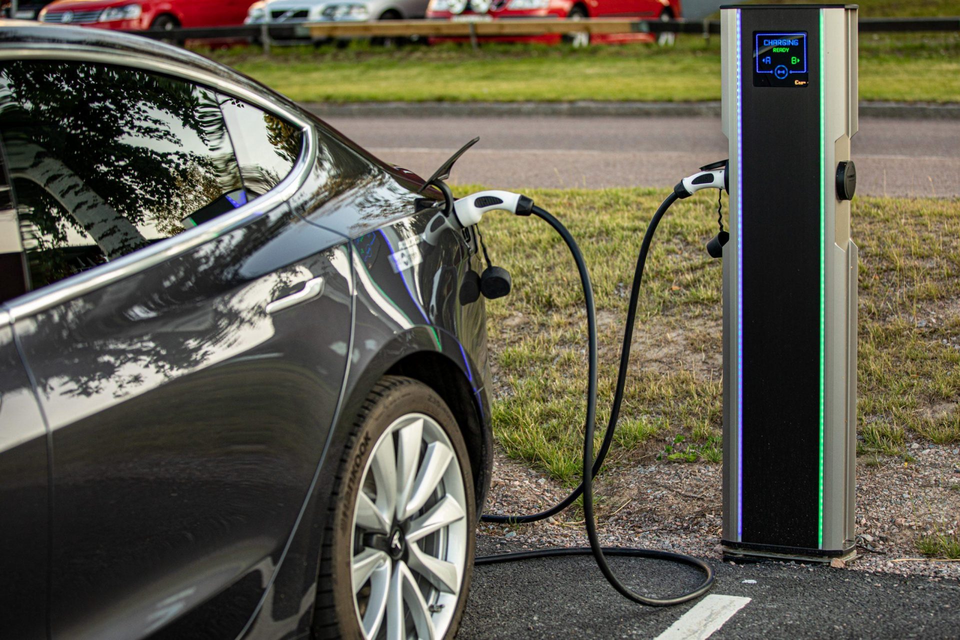 Voiture électrique branchée à une borne de recharge avec bandes lumineuses